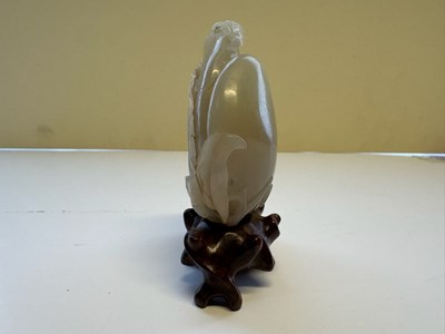 Lot 22 - A CHINESE PALE CELADON JADE 'PEACH AND BAT' GROUP, QING DYNASTY, 18TH CENTURY