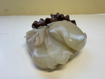 Lot 22 - A CHINESE PALE CELADON JADE 'PEACH AND BAT' GROUP, QING DYNASTY, 18TH CENTURY