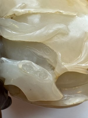 Lot 22 - A CHINESE PALE CELADON JADE 'PEACH AND BAT' GROUP, QING DYNASTY, 18TH CENTURY