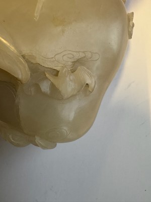 Lot 22 - A CHINESE PALE CELADON JADE 'PEACH AND BAT' GROUP, QING DYNASTY, 18TH CENTURY