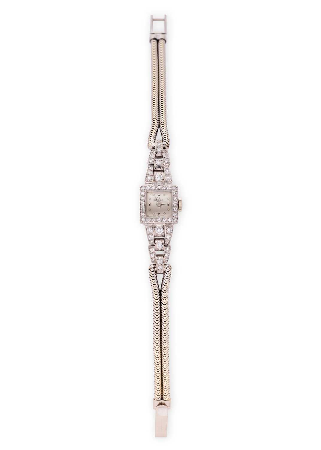 Lot 331 - OMEGA: LADY'S WHITE GOLD AND DIAMOND COCKTAIL WATCH, 1950s