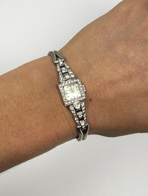 Lot 331 - OMEGA: LADY'S WHITE GOLD AND DIAMOND COCKTAIL WATCH, 1950s