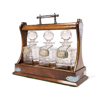 Lot 126 - AN ELECTROPLATE-MOUNTED THREE-BOTTLE OAK TANTALUS, ENGLISH, CIRCA 1900