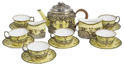 Lot 266 - AN EDWARDIAN SILVER AND PORCELAIN THREE-PIECE TEA SET AND SIX CUPS AND SAUCERS