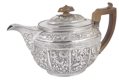 Lot 335 - A GEORGE III AND LATER CHASED SILVER TEAPOT