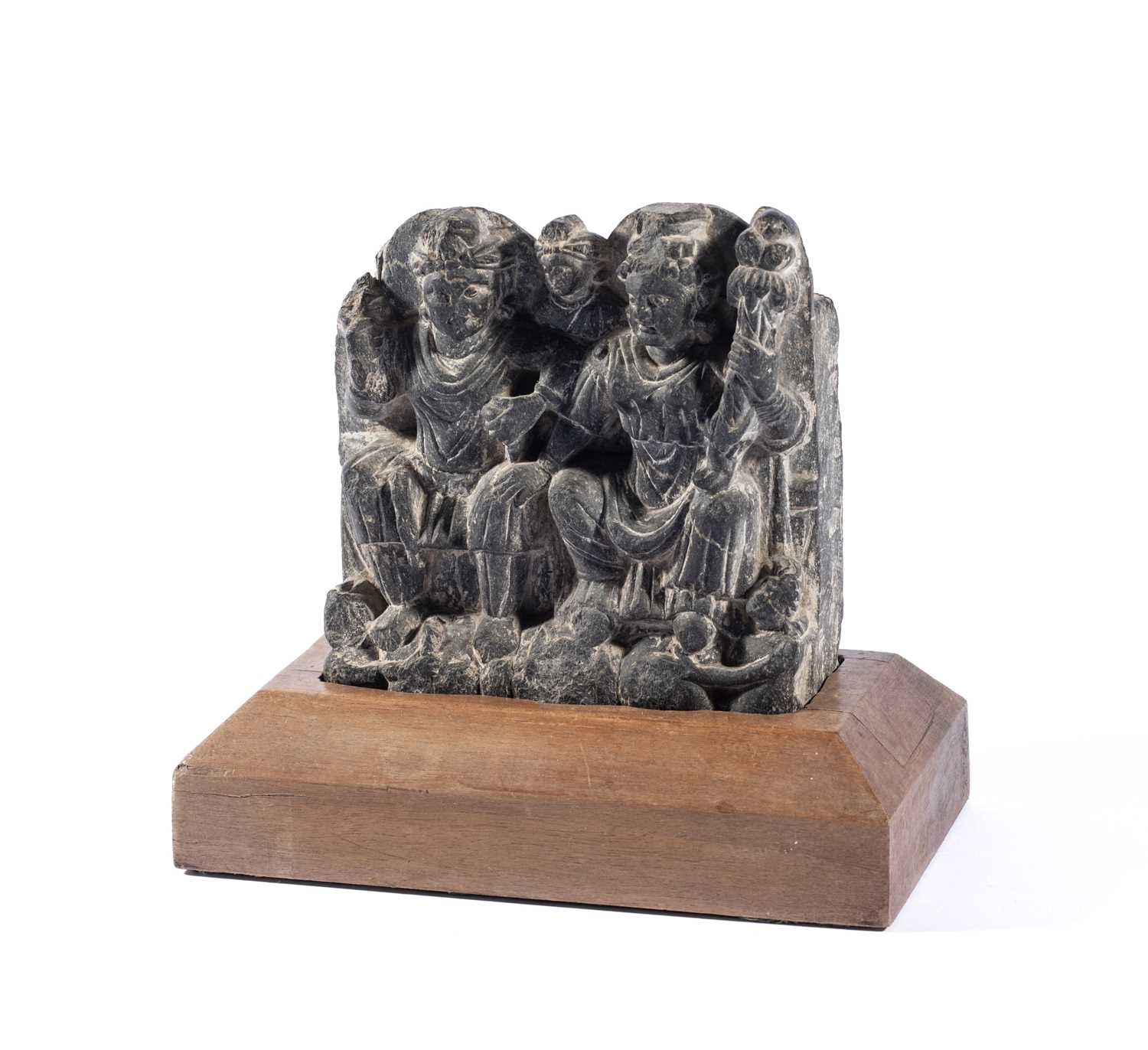 Lot 89 - A GANDHARA GREY SCHIST RELIEF DEPICTING HARITI AND PANCHIKA, NORTH-WESTERN PAKISTAN, 3RD/4TH CENTURY