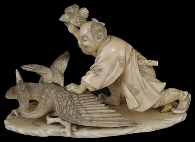 Lot 331 - ~A JAPANESE SECTIONAL IVORY OKIMONO OF A BIRD KEEPER