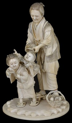 Lot 332 - ~A JAPANESE IVORY OKIMONO OF A WOMAN AND CHILDREN