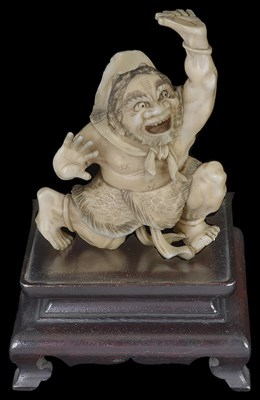 Lot 334 - ~A JAPANESE IVORY OKIMONO OF AN ONI