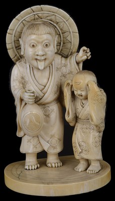 Lot 335 - ~A JAPANESE IVORY OKIMONO OF AN ONI AND BOY