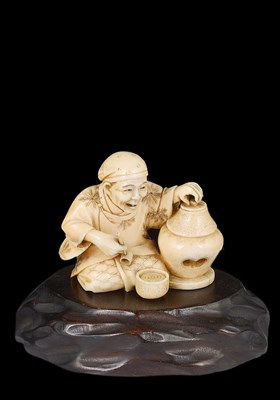 Lot 340 - ~A JAPANESE IVORY OKIMONO OF A PIPE SMOKER