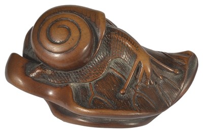 Lot 352 - ~A JAPANESE WOOD NETSUKE OF A SNAIL ON LOTUS LEAF