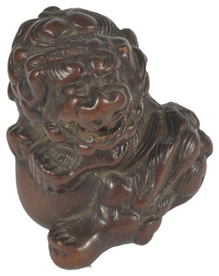 Lot 353 - A JAPANESE PLUM WOOD NETSUKE OF A SHISHI