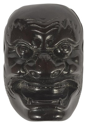 Lot 372 - ~A JAPANESE EBONY MASK NETSUKE OF A FIERCE ONI