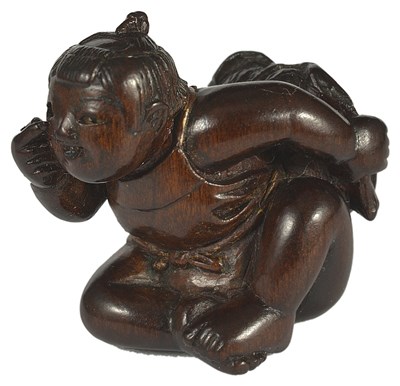 Lot 376 - A JAPANESE WOOD NETSUKE OF A CHILD DOING BEKKAKO