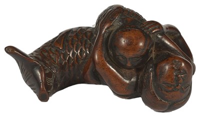 Lot 392 - A JAPANESE WOOD NETSUKE OF A NURSING MERMAID