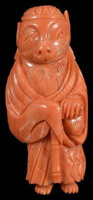 Lot 397 - A JAPANESE CORAL NETSUKE OF A TRANSFORMING BADGER