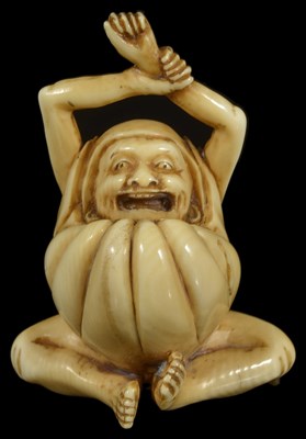 Lot 402 - ~A JAPANESE IVORY NETSUKE OF DARUMA