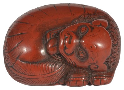 Lot 407 - A JAPANESE RED LACQUER NETSUKE OF A SHISHI