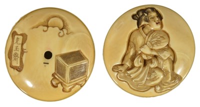 Lot 409 - ~A JAPANESE IVORY TWO-PART MANJU NETSUKE