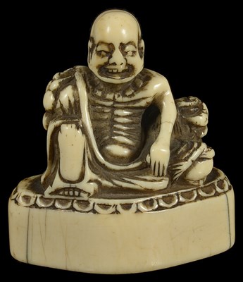 Lot 411 - ~A JAPANESE IVORY TOBORI NETSUKE OF A RAKAN