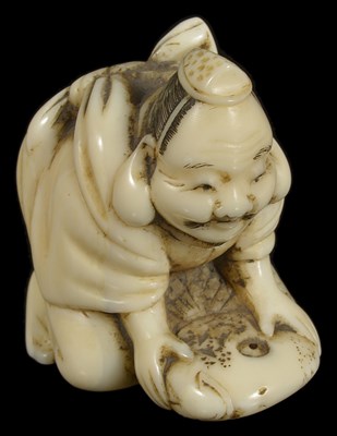 Lot 414 - ~A JAPANESE WALRUS IVORY NETSUKE OF EBISU