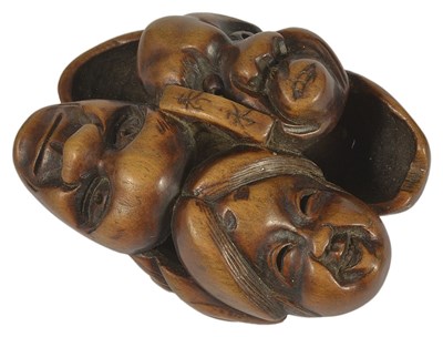 Lot 421 - A JAPANESE WOOD NETSUKE OF MASKS BY HIDENAGA