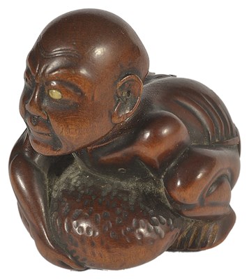 Lot 422 - ~A JAPANESE WOOD NETSUKE OF A BLIND MASSEUR