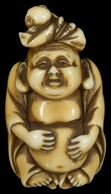 Lot 430 - ~A JAPANESE STAINED IVORY NETSUKE OF HOTEI WITH A CHILD ON HIS HEAD