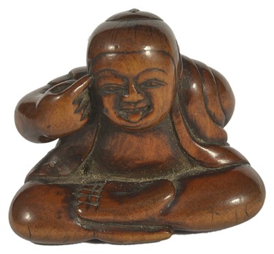 Lot 435 - A JAPANESE WOOD NETSUKE OF A BOY DOING BEKKAKO