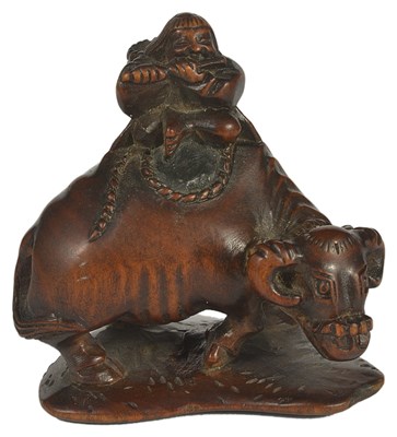 Lot 438 - A JAPANESE WOOD NETSUKE OF A HERD-BOY ON AN OX