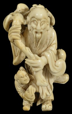 Lot 445 - ~A JAPANESE IVORY NETSUKE OF A CHINESE SAGE AND BOY