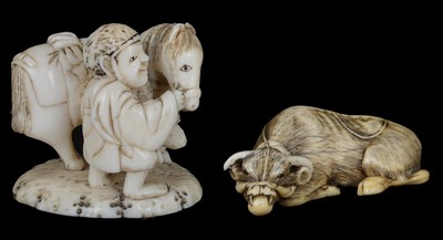 Lot 461 - ~A JAPANESE IVORY NETSUKE OF A RECUMBENT OX