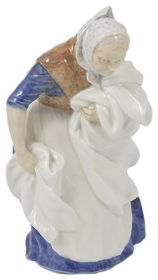 Lot 494 - A ROYAL COPENHAGEN FIGURE OF AN OLD WOMAN WITH WASHING