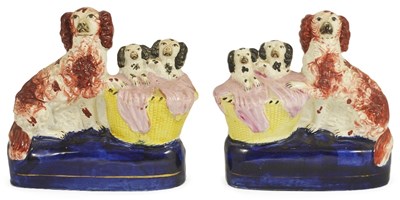 Lot 495 - AN OPPOSING PAIR OF STAFFORDSHIRE FLAT-BACK GROUPS OF DOGS WITH PUPS IN BASKETS