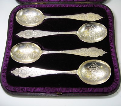 Lot 543 - A SET OF FOUR VICTORIAN PARCEL-GILT SILVER FRUIT SERVING SPOONS