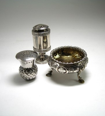 Lot 654 - A SILVER SALT CELLAR AND TWO PEPPERETTES