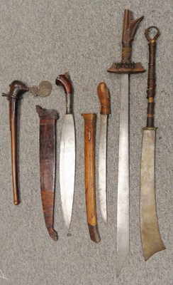 Lot 35 - â€¡ FOUR SOUTH EAST ASIAN EDGED WEAPONS AND A PACIFIC AXE