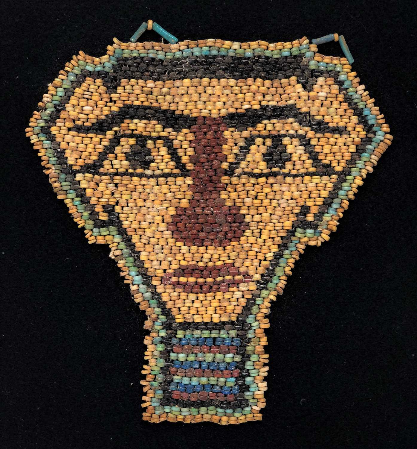 Lot 84 - AN EGYPTIAN BEAD 'MUMMY' MASK, LATE DYNASTIC