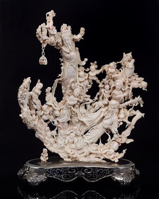 Lot 15 - A CHINESE CARVED CREAM CORAL GROUP ON SILVER STAND