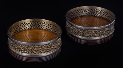 Lot 76 - A PAIR OF PARCEL-GILT-SILVER WINE COASTERS