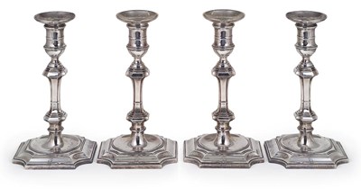 Lot 97 - A SET OF FOUR GEORGE V SILVER CANDLESTICKS