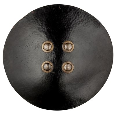 Lot 191 - AN INDIAN BLACK LACQUERED BUFFALO HIDE SHIELD (DHAL), 18TH/19TH CENTURY